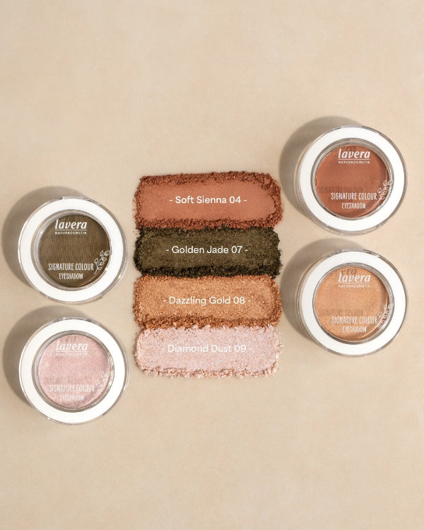 Four lavera eyeshadow swatches in the shades Soft Sienna, Golden Jade, Dazzling Gold and Diamond Dust next to the product pots.