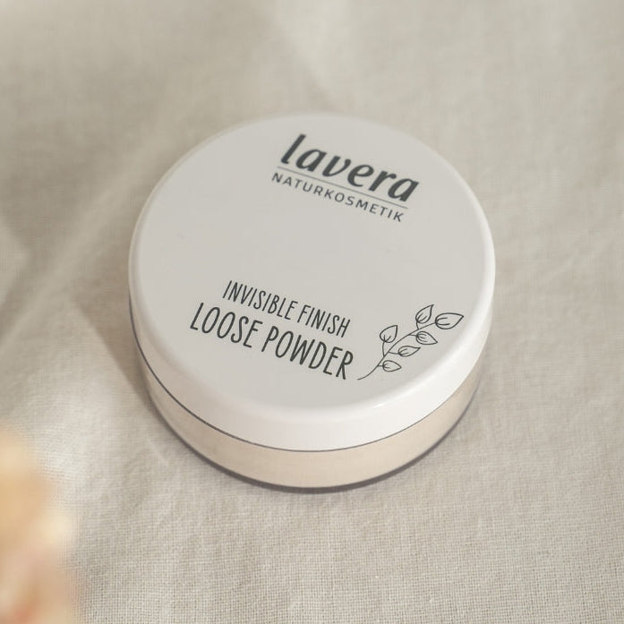 Invisible Finish Loose Powder against a linen background