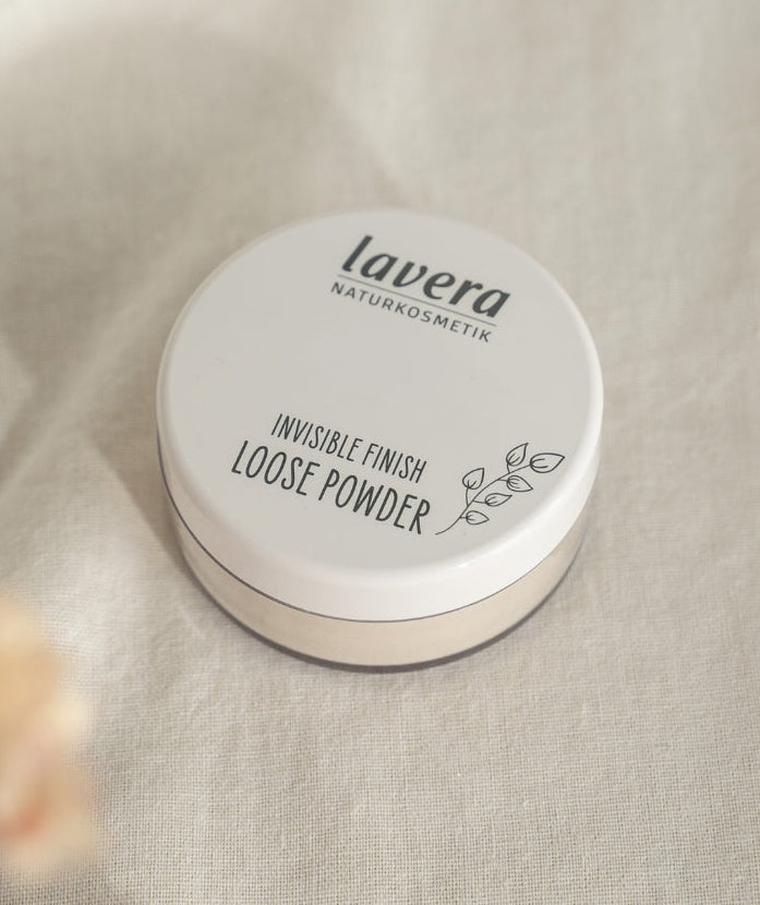 Invisible Finish Loose Powder against a linen background