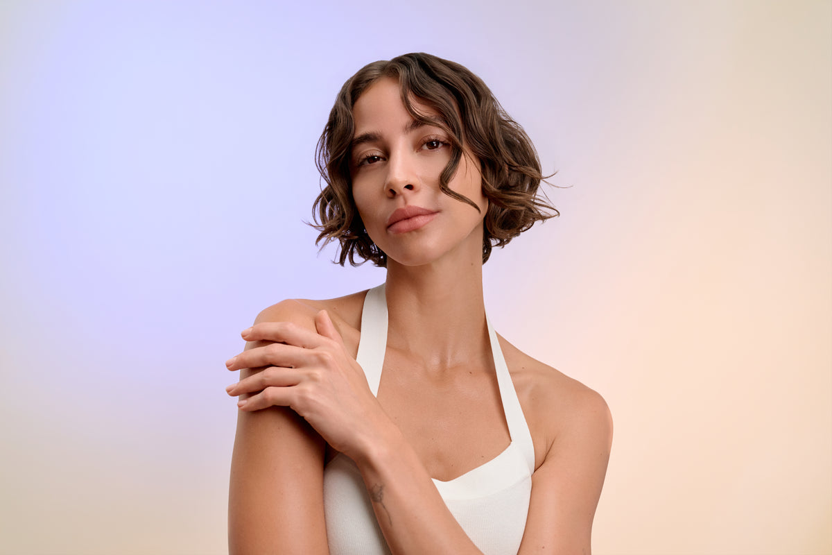 Portrait of a woman with shoulder-length, curly brown hair