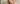 A blonde woman with natural, subtle makeup gazes attentively and confidently into the camera